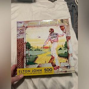 Elton John yellow brick road puzzle. New in box made by rose art